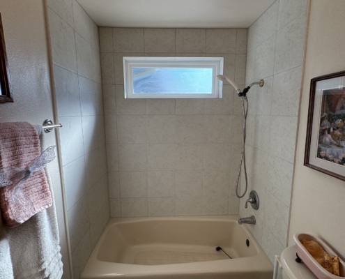 A completed project with a new window above the tub