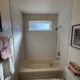 A completed project with a new window above the tub